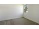 Bright, carpeted bedroom with a large window providing natural light at 9071 Players Dr, Weeki Wachee, FL 34613
