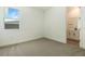 Well-lit bedroom offering carpeted floors and an adjacent bathroom for convenience at 9071 Players Dr, Weeki Wachee, FL 34613