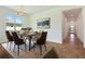 Bright dining room featuring modern chandelier, stylish furniture and decorative wall art at 9071 Players Dr, Weeki Wachee, FL 34613
