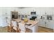 Modern kitchen features white cabinetry, stainless steel appliances, a butcher block island, and bar stool seating at 9071 Players Dr, Weeki Wachee, FL 34613