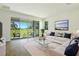 Bright living room with a view of the backyard patio through large sliding glass doors at 9071 Players Dr, Weeki Wachee, FL 34613