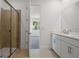 Modern bathroom with glass shower and white cabinets at 9093 Players Dr, Weeki Wachee, FL 34613
