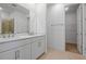Modern bathroom with double vanity, walk-in closet, and a glass shower at 9093 Players Dr, Weeki Wachee, FL 34613
