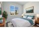 Comfortable bedroom featuring a queen size bed, night stands, and a large picture window at 9093 Players Dr, Weeki Wachee, FL 34613