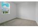Cozy, carpeted bedroom with a large window offering natural light at 9093 Players Dr, Weeki Wachee, FL 34613
