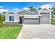 Well-maintained home with a stone-accented facade and a spacious three-car garage at 9093 Players Dr, Weeki Wachee, FL 34613