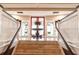 Grand foyer with staircase and decorative flower arrangement creating an inviting entrance at 9093 Players Dr, Weeki Wachee, FL 34613