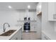 Bright kitchen featuring white cabinets, stainless appliances, and a center island at 9093 Players Dr, Weeki Wachee, FL 34613