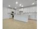 Open kitchen with white cabinetry, a large island, and stainless steel appliances at 9093 Players Dr, Weeki Wachee, FL 34613