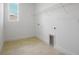 Bright laundry room features wood-look tile flooring, a window, and a white wire storage shelf at 9093 Players Dr, Weeki Wachee, FL 34613