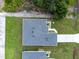 Aerial view of a single-Gathering home with gray roof, driveway, and green lawn at 183 Wright Drive, Rotonda West, FL 33947