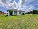 Expansive backyard featuring well-maintained lawn and views of the surrounding landscape at 183 Wright Drive, Rotonda West, FL 33947