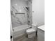 Modern bathroom with marble shower, niche, and wood-look tile flooring at 183 Wright Drive, Rotonda West, FL 33947