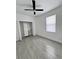 Bright bedroom with ceiling fan, modern closet, and wood-look tile flooring at 183 Wright Drive, Rotonda West, FL 33947