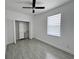 Bright bedroom with ceiling fan, modern closet, and wood-look tile flooring at 183 Wright Drive, Rotonda West, FL 33947