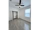 Bedroom with double door closet, ceiling fan, and large window, providing ample natural light at 183 Wright Drive, Rotonda West, FL 33947