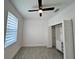 This bedroom features neutral paint, tiled floors, a ceiling fan and a closet at 183 Wright Drive, Rotonda West, FL 33947