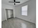 Bright bedroom with ceiling fan, modern closet, and wood-look tile flooring at 183 Wright Drive, Rotonda West, FL 33947