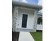 Close-up of a home's front entrance with stone accents and manicured landscaping at 183 Wright Drive, Rotonda West, FL 33947