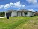 A well-maintained single-story home with a lush lawn and an inviting front entrance at 183 Wright Drive, Rotonda West, FL 33947