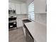 Modern kitchen features stainless steel appliances and quartz countertops at 183 Wright Drive, Rotonda West, FL 33947