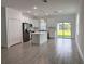 Bright, open-concept kitchen featuring a center island, stainless steel appliances, and sleek white cabinets at 183 Wright Drive, Rotonda West, FL 33947