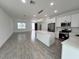 Kitchen showcases white cabinets, a center island, stainless steel appliances, and modern pendant lighting at 183 Wright Drive, Rotonda West, FL 33947
