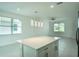 Kitchen with island, pendant lighting, and a view into the living room and backyard at 183 Wright Drive, Rotonda West, FL 33947