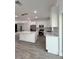Modern kitchen with white cabinets, stainless steel appliances, and a large center island at 183 Wright Drive, Rotonda West, FL 33947
