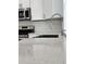 Close-up of kitchen sink area showing stainless steel appliances and white cabinets at 183 Wright Drive, Rotonda West, FL 33947