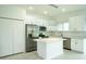Bright, modern kitchen with stainless steel appliances, island and white cabinets at 183 Wright Drive, Rotonda West, FL 33947