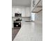 Close-up of a modern kitchen showcasing white quartz countertops and stainless steel appliances at 183 Wright Drive, Rotonda West, FL 33947