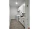 Modern laundry room with front load washer/dryer and countertop sink at 183 Wright Drive, Rotonda West, FL 33947