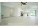 Open-concept living space flows into a kitchen with white cabinets and stainless steel appliances at 183 Wright Drive, Rotonda West, FL 33947
