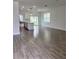 Open-concept living space with tile flooring, modern lighting, and sliding glass doors to the backyard at 183 Wright Drive, Rotonda West, FL 33947