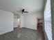 Spacious main bedroom features stylish tile flooring, ceiling fan, and walk-in closet entrance at 183 Wright Drive, Rotonda West, FL 33947