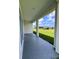 Covered porch with views of the green lawn and blue sky at 183 Wright Drive, Rotonda West, FL 33947
