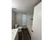 Bathroom features wood-look floors, a shower-tub combo, and white subway tile surround at 7403 Foxbloom Dr, Port Richey, FL 34668