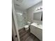 Bathroom featuring a glass-enclosed shower, modern fixtures, and wood-look vinyl flooring at 7403 Foxbloom Dr, Port Richey, FL 34668