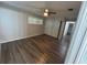 Bright bedroom features wood-look flooring, ceiling fan, and closet with sliding doors at 7403 Foxbloom Dr, Port Richey, FL 34668