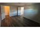 Inviting bedroom with wood-look floors, neutral paint, and ample natural light from the windows at 7403 Foxbloom Dr, Port Richey, FL 34668