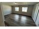 Bright bedroom with new wood laminate flooring and sun-filled windows at 7403 Foxbloom Dr, Port Richey, FL 34668