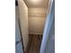 Walk-in closet featuring rod and wire shelving with wood-look flooring at 7403 Foxbloom Dr, Port Richey, FL 34668