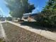Charming single story home featuring desert landscaping, a large tree, and stone accents at 7403 Foxbloom Dr, Port Richey, FL 34668