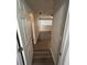 Hallway featuring wood-look floors leads to a naturally lit bedroom, enhancing the home's appeal at 7403 Foxbloom Dr, Port Richey, FL 34668