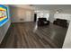 Large living room featuring new wood laminate flooring at 7403 Foxbloom Dr, Port Richey, FL 34668