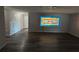 Spacious living room with new wood laminate flooring and a stained-glass mosaic accent at 7403 Foxbloom Dr, Port Richey, FL 34668