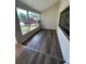 Sunroom with new wood laminate flooring, with access to front yard views at 7403 Foxbloom Dr, Port Richey, FL 34668