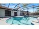 Backyard pool with a patio area and a screened enclosure for outdoor living at 4907 Parson Brown Ln, Palm Harbor, FL 34684