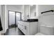 Bathroom featuring double vanity with black countertop, a water closet, and black tiled floors at 4907 Parson Brown Ln, Palm Harbor, FL 34684